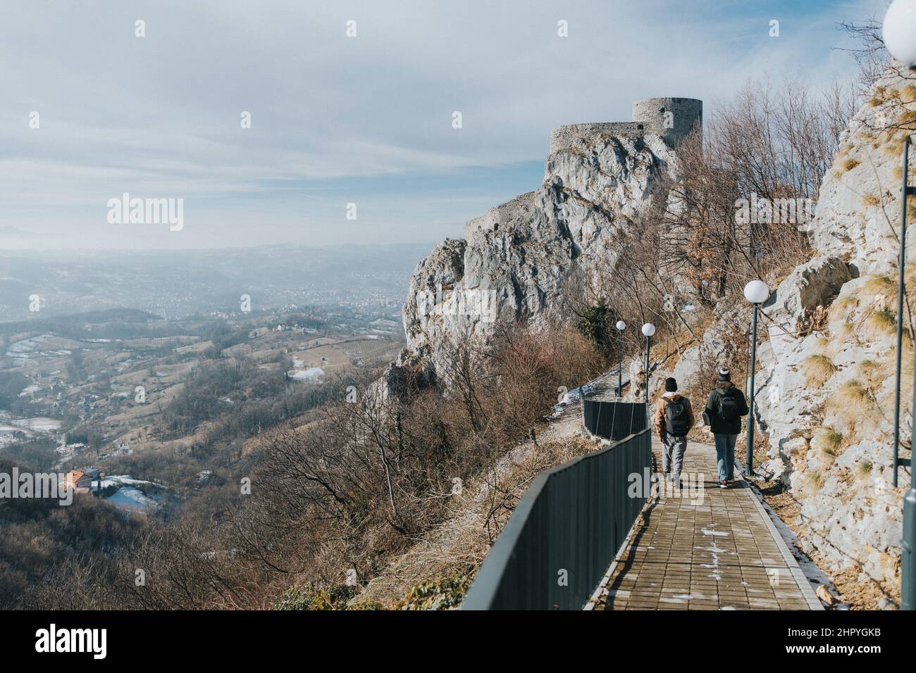 A back view of two tourists walking towards the famous Srebrenik Fortress Stock Photo