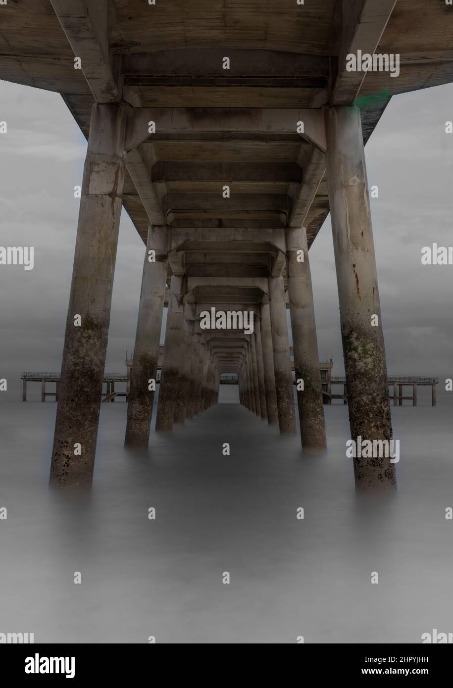 Low angle shot of a wooden pier at a beach on a foggy day Stock Photo ...