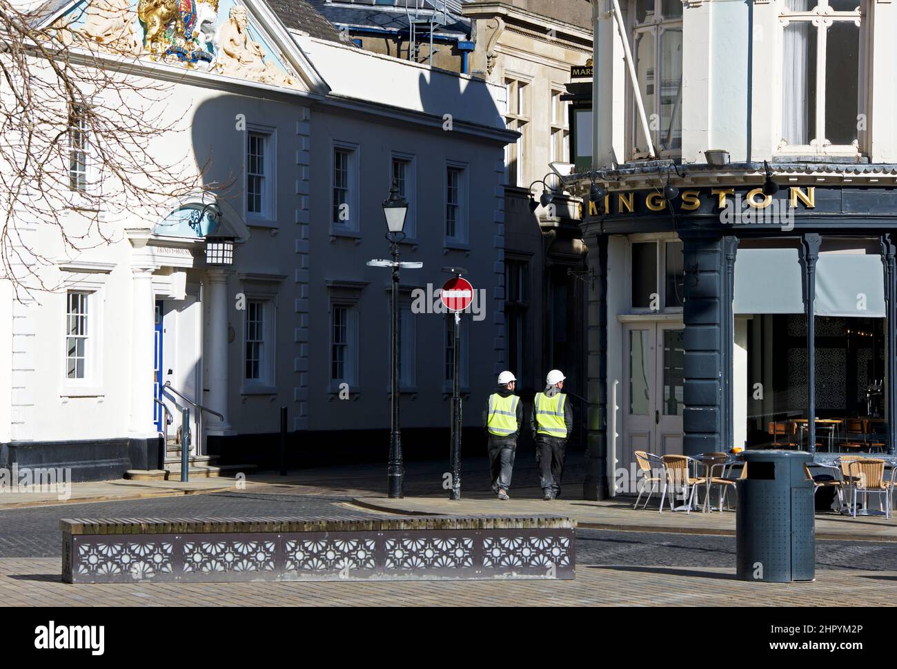 Two men in hi-vis jackets walking through Trinity Square, Hull, Humberside, East Yorkshire, England UK Stock Photo