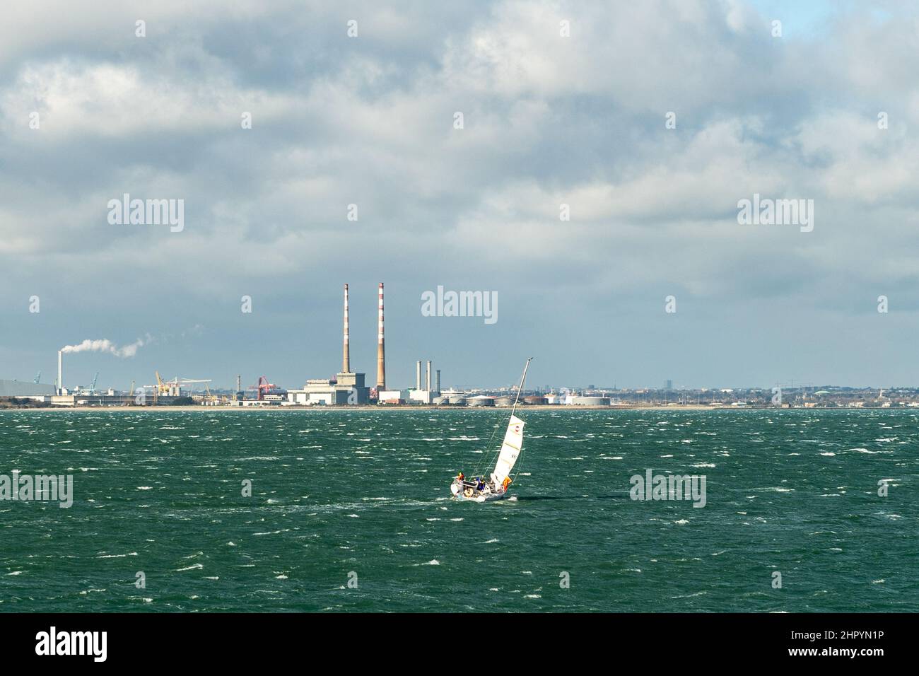 Dun Laoghaire, Ireland. 24th Feb, 2022. A yacht leaves Dun Laoghaire harbour in the midst of very high winds. Met Éireann has forecast wintry showers for the rest of the day. Credit: AG News/Alamy Live News Stock Photo