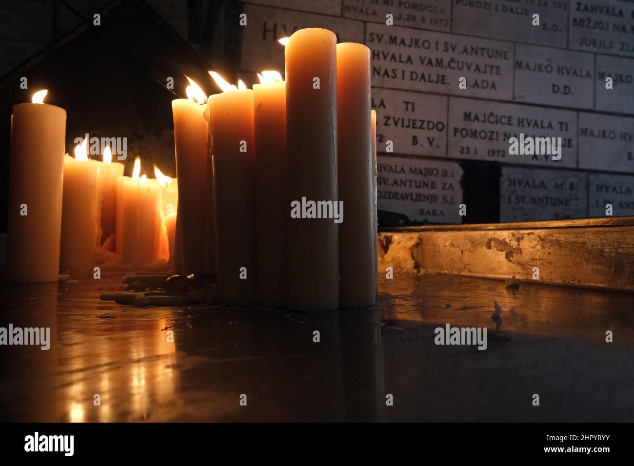 Lighting candles in chapel of Our Lady from the Kamenita vrata (Stone