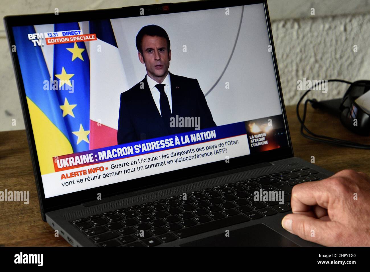 Marseille, France. 24th Feb, 2022. A man watches Emmanuel Macron's televised speech against the war in Ukraine on his computer.After Russia's offensive in Ukraine, the President of the French Republic Emmanuel Macron addressed the French in a televised address to inform them of the situation while strongly condemning this action by Vladimir Putin. (Photo by Gerard Bottino/SOPA Images/Sipa USA) Credit: Sipa USA/Alamy Live News Stock Photo