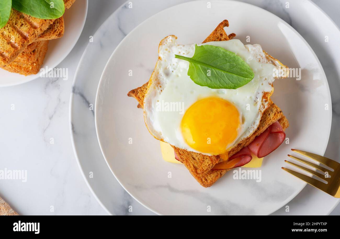 Sandwich with a fried egg, bacon, cheese and spinach Stock Photo Alamy