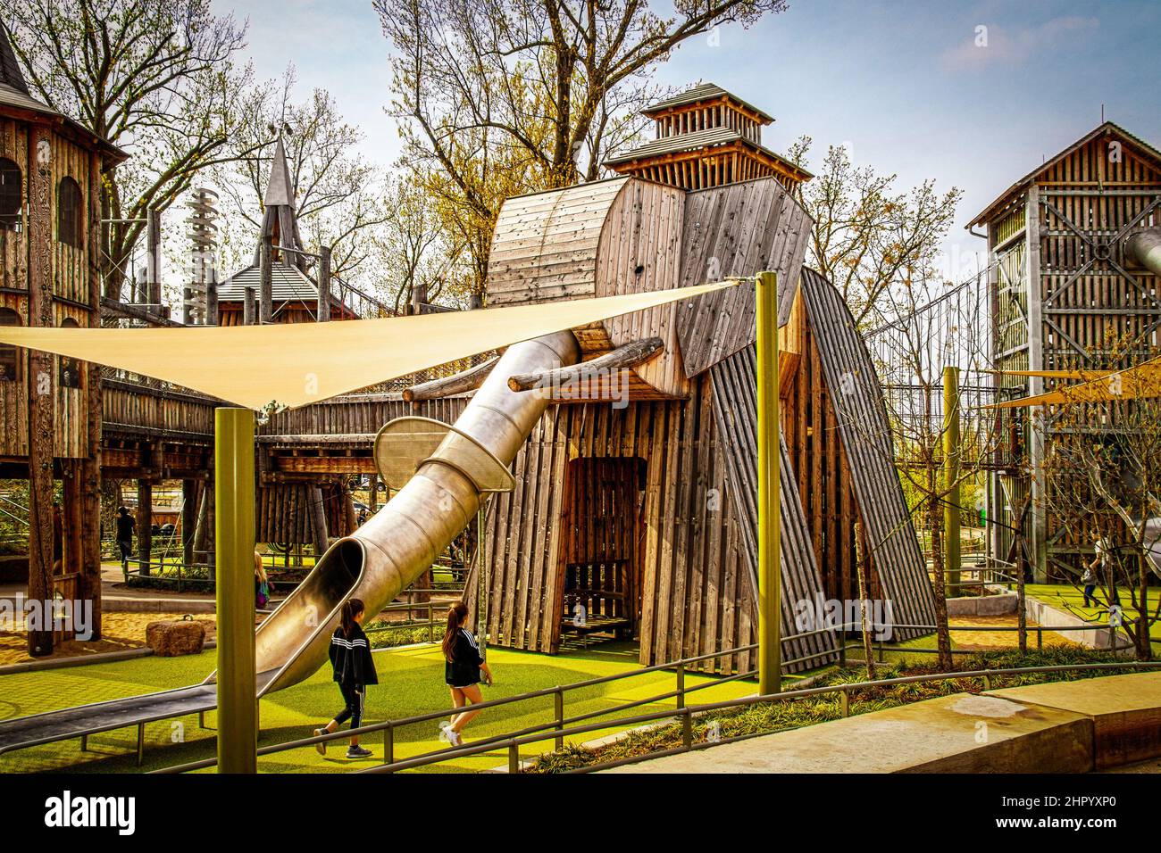 2019 04 06 Tulsa OK USA - Wooden Elephant Climbing castle with slide for trunk and sail awning with children playing in Springtime at The Gathering Pl Stock Photo