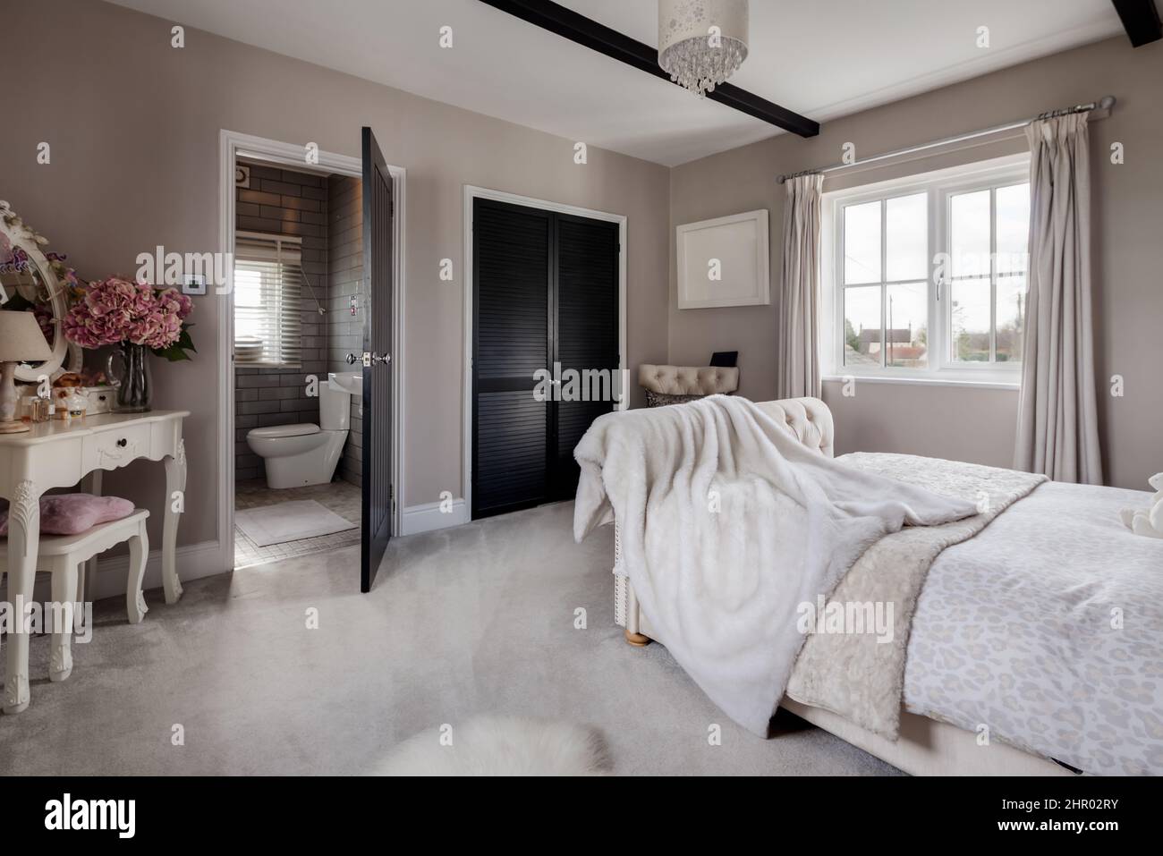 Beautiful stylish luxury bedroom dressed with stylish furniture and