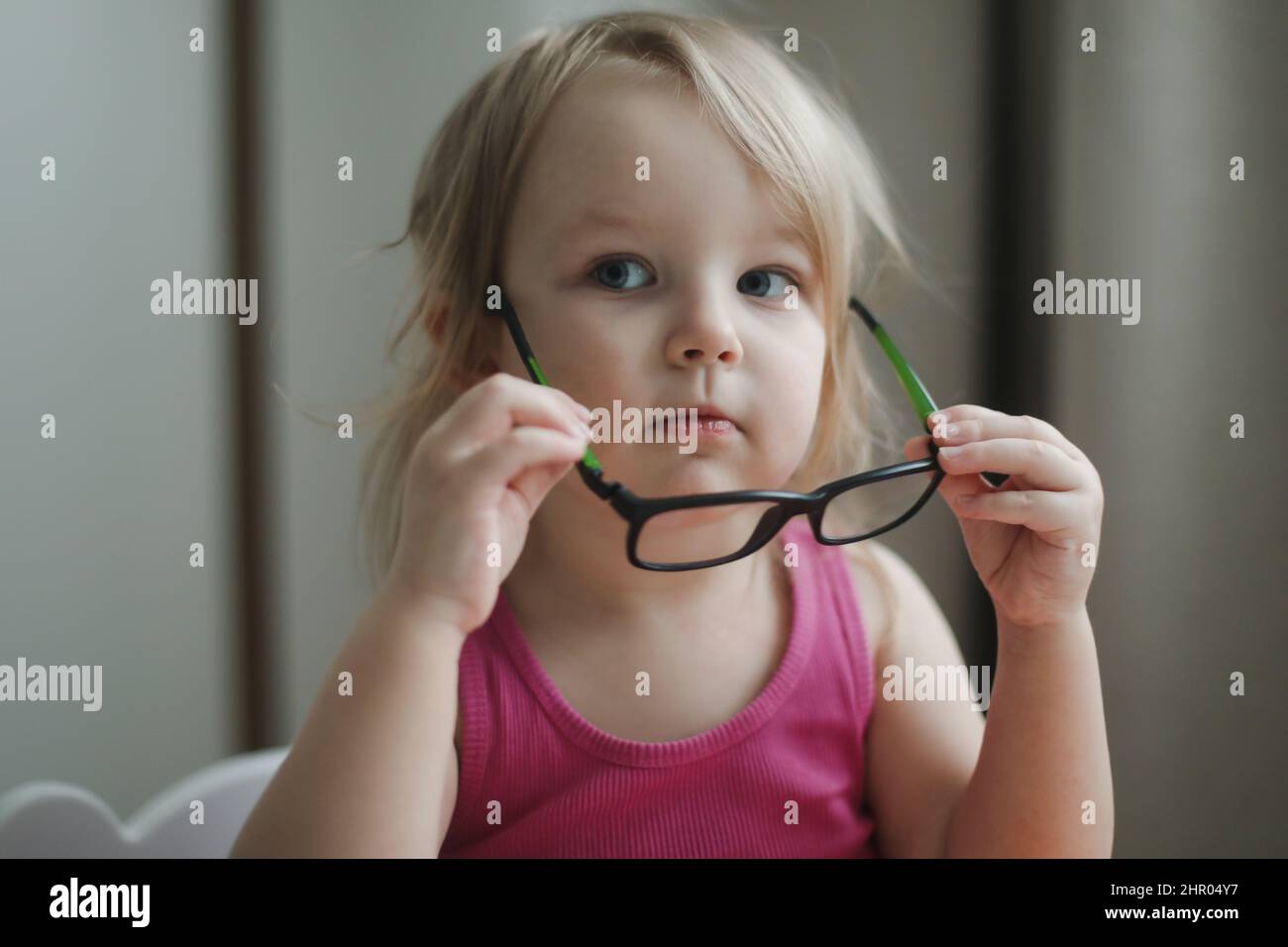 portrait of a little funny girl in eyeglasses Stock Photo