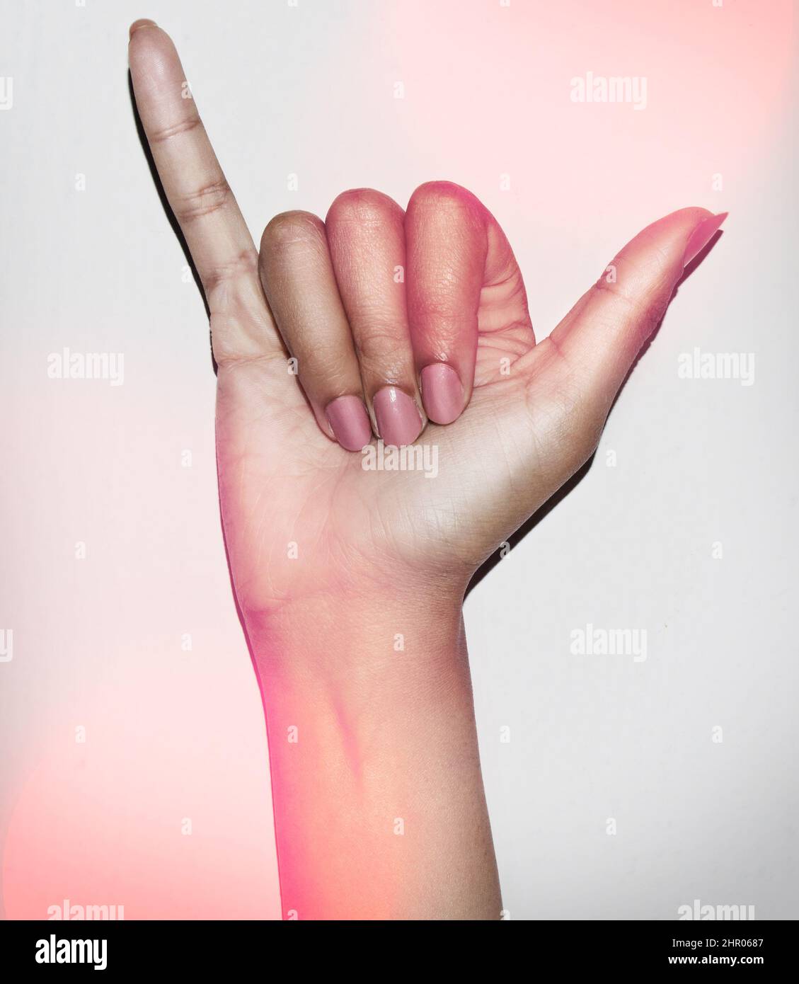 Feeling superstitious. Cropped shot of a hand giving the hang ten signshaka. Stock Photo