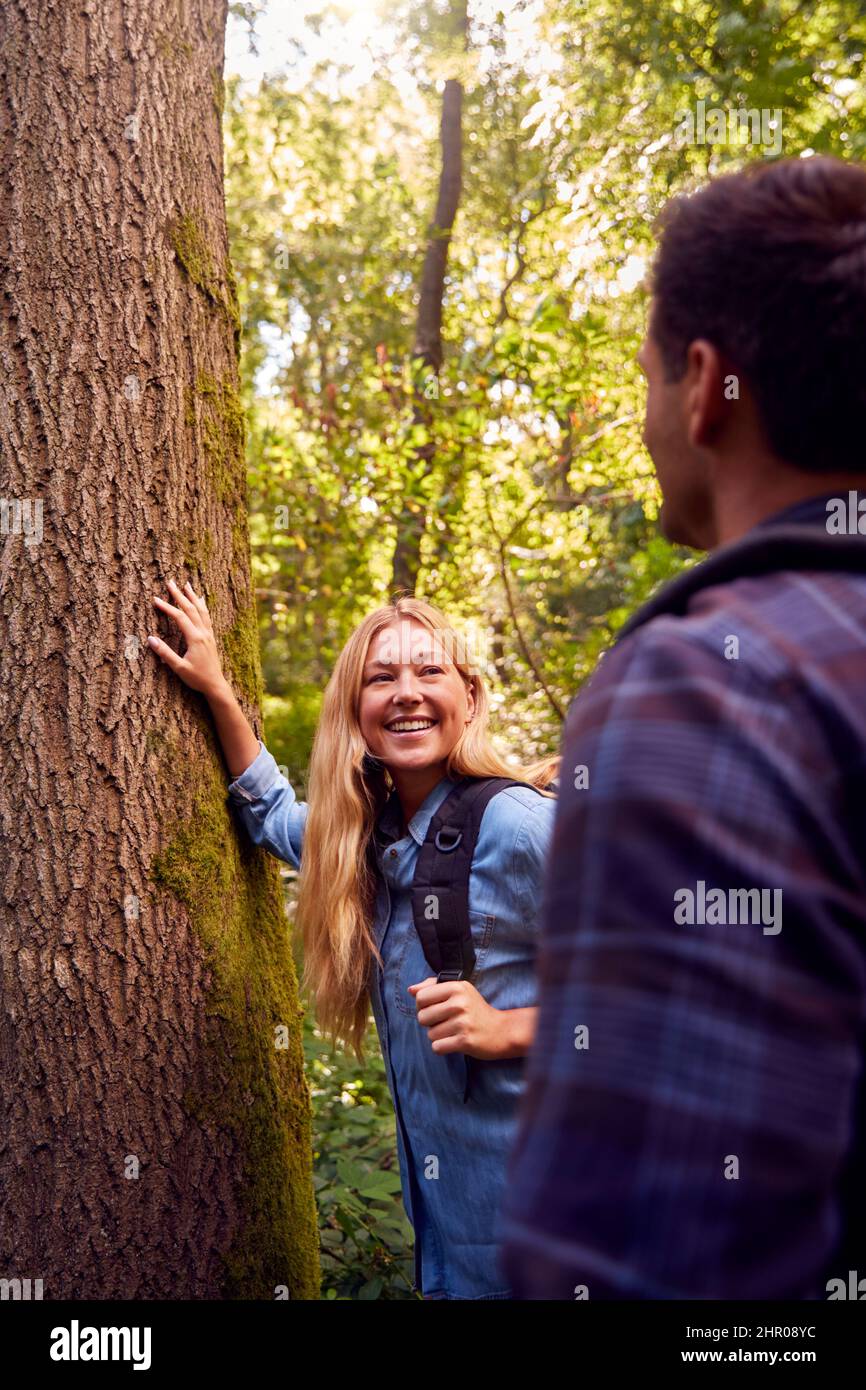 Couple In Countryside Hiking Along Path Through Forest Together Stock Photo