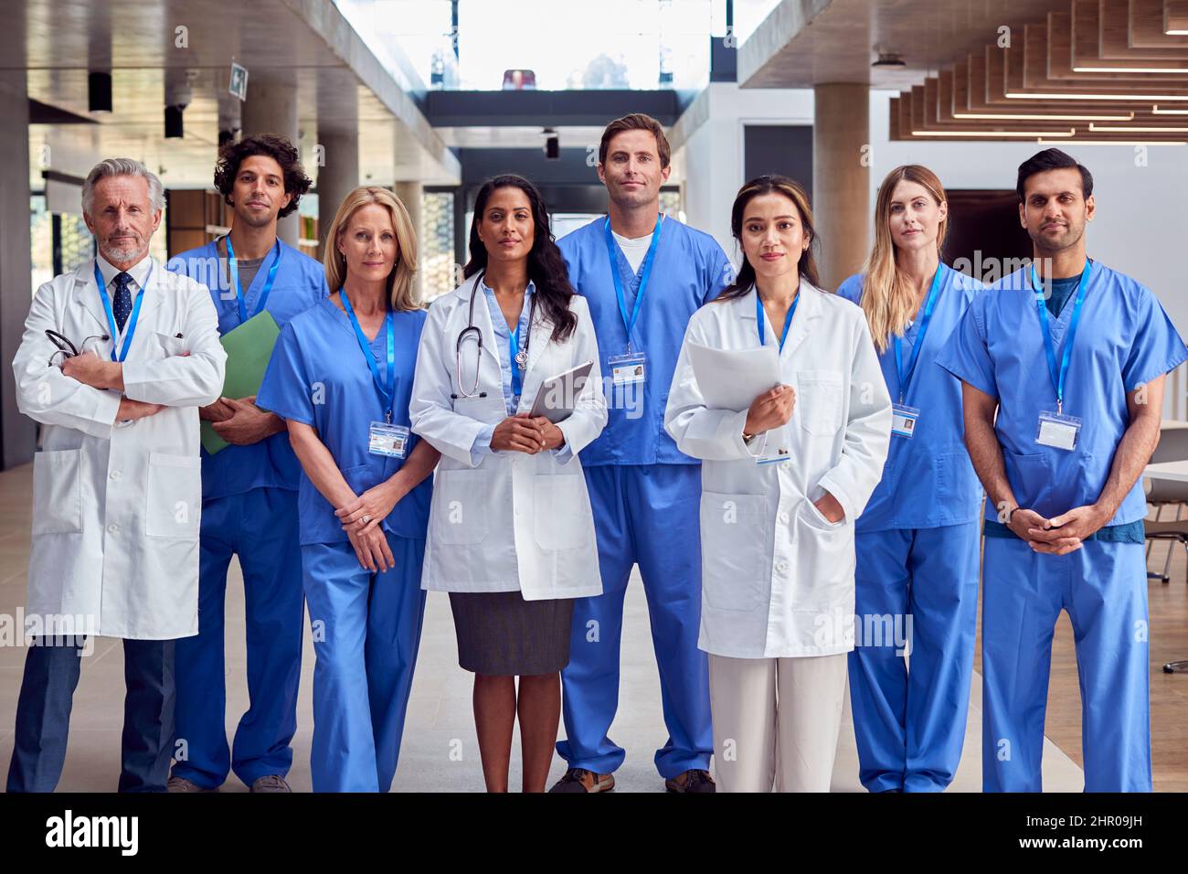 Portrait Of Multi-Cultural Medical Team Wearing Uniform Standing Inside Hospital Building Stock Photo