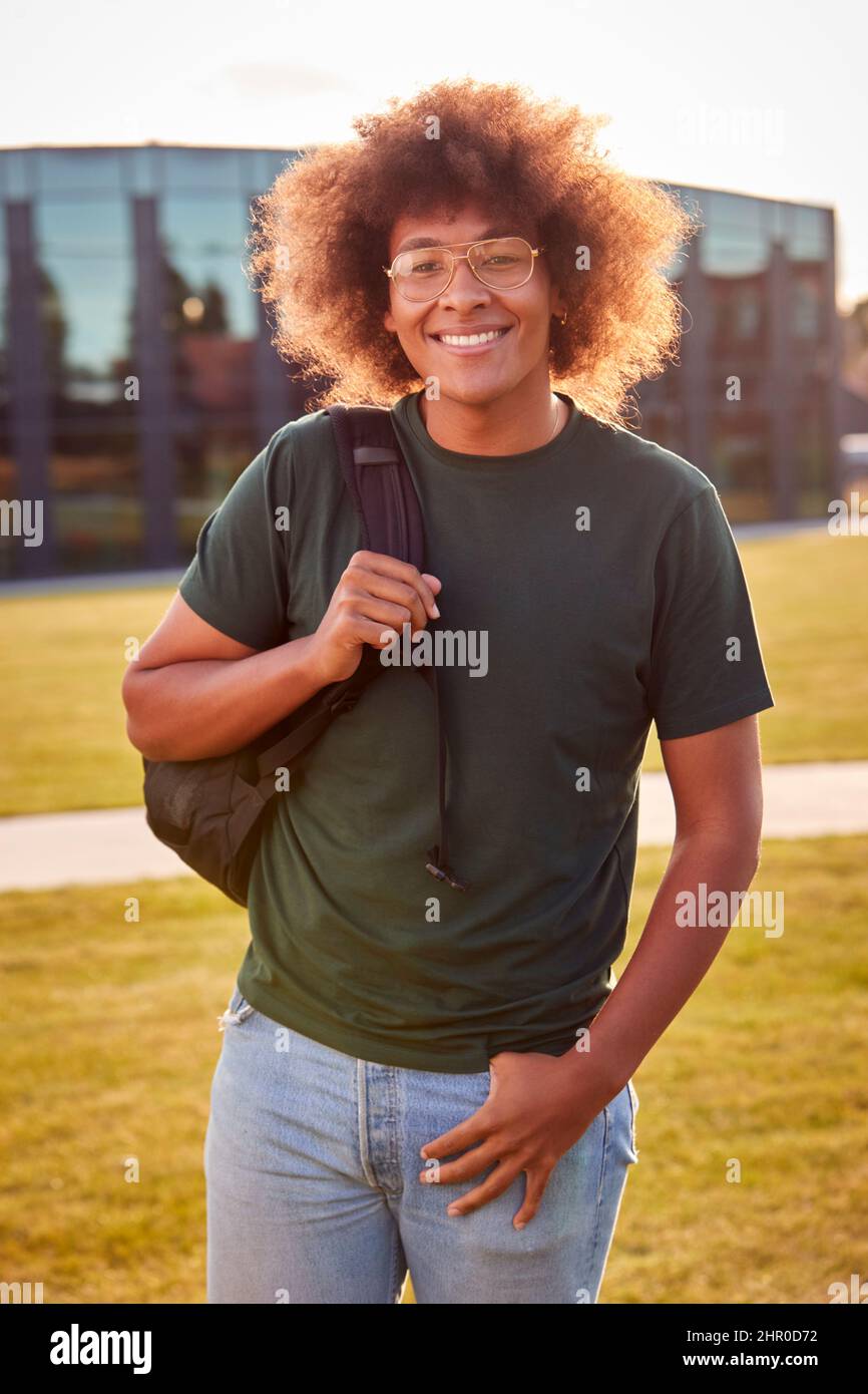 Portrait Of Male University Or College Student Standing Outdoors By Modern Campus Building Stock Photo