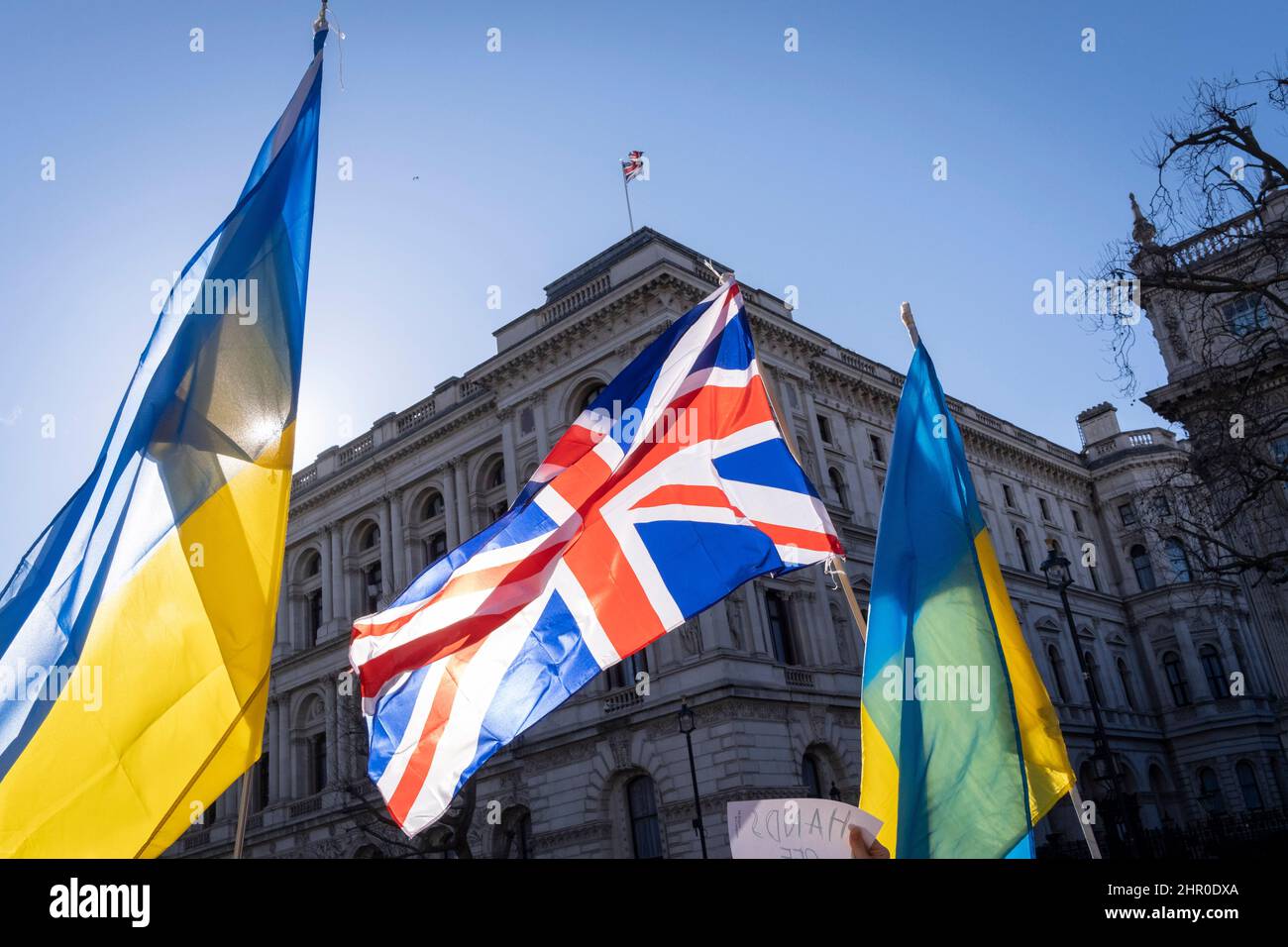 Following Russia’s invasion of Ukraine overnight, Ukrainians protest with their national flag and the British Union Jack opposite Downing Street, on 24th February 2022, in London, England. Stock Photo