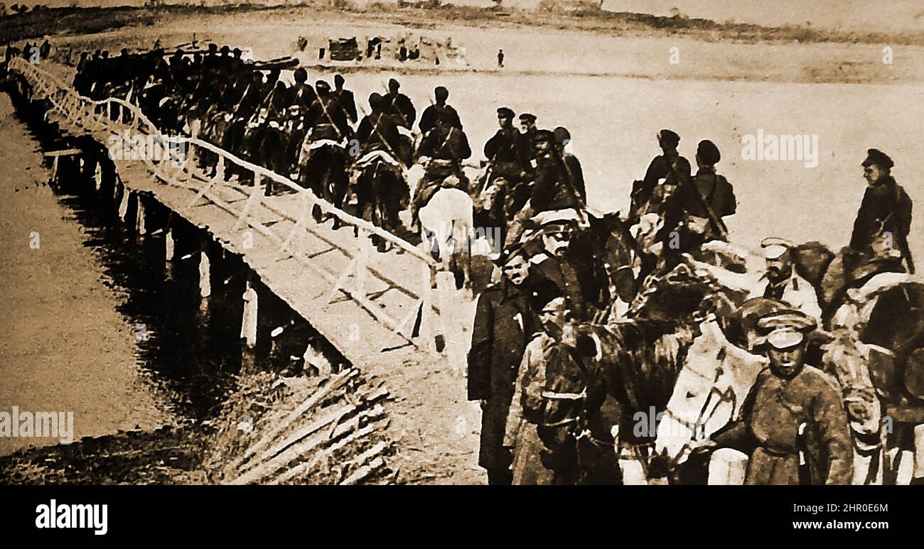 World War I  - Russian cavalry attempting to cross a war damaged woodenbridge Stock Photo