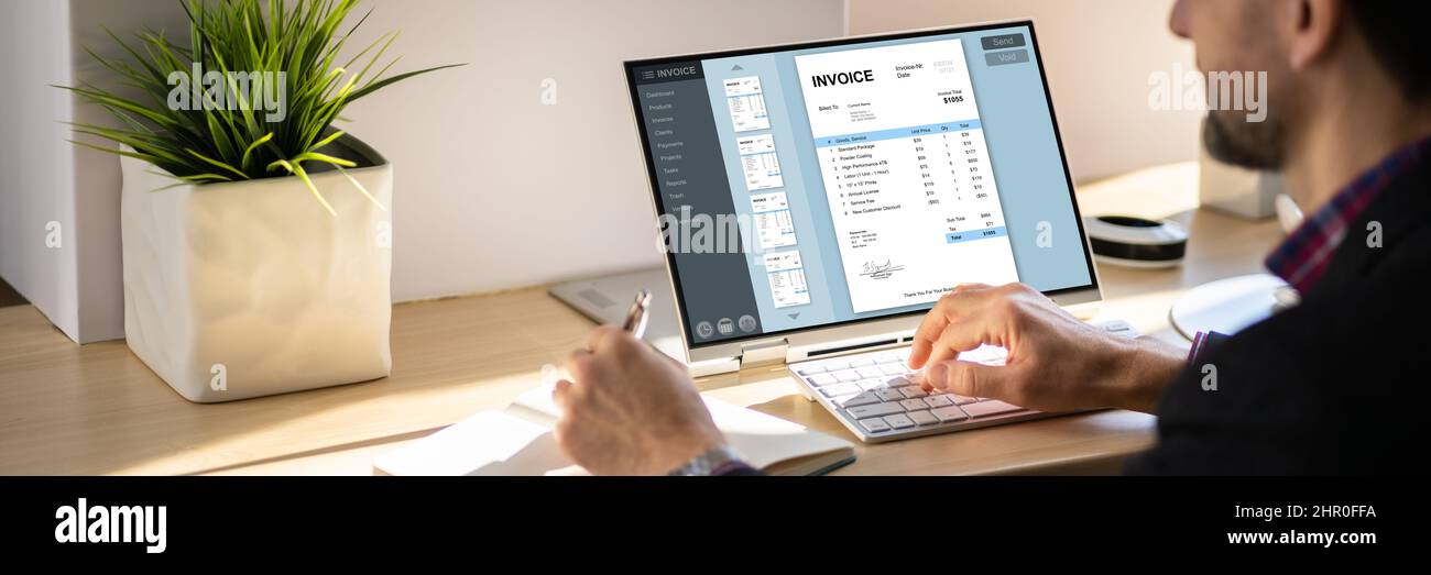 Accountant Using Online E Invoice Software On Tablet Stock Photo