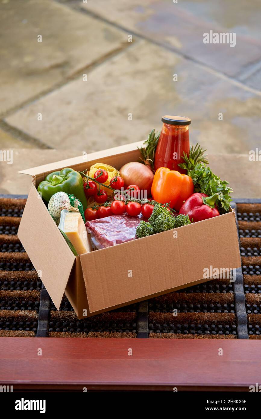Box Of Fresh Ingredients For Online Meal Food Recipe Kit Delivered To Home On Doorstep Stock Photo