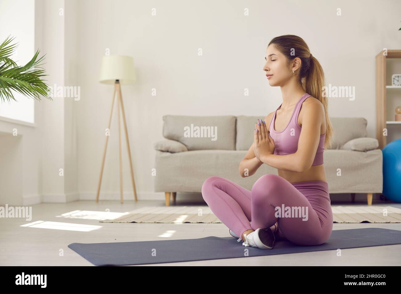 Calm girl practice yoga meditate at home Stock Photo