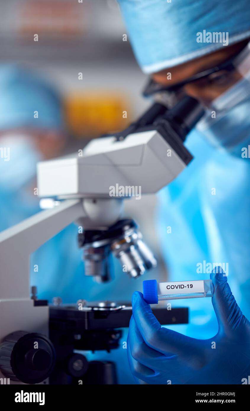 Close Up Of Female Lab Worker Wearing PPE Researching Covid-19 With ...