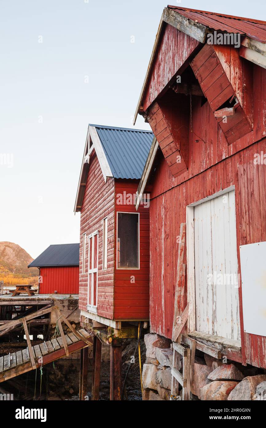 Norwegian red wooden barns standing on the sea coast, close-up. Snillfjord, Sor-Trondelag region, Vingvagen fishing village Stock Photo