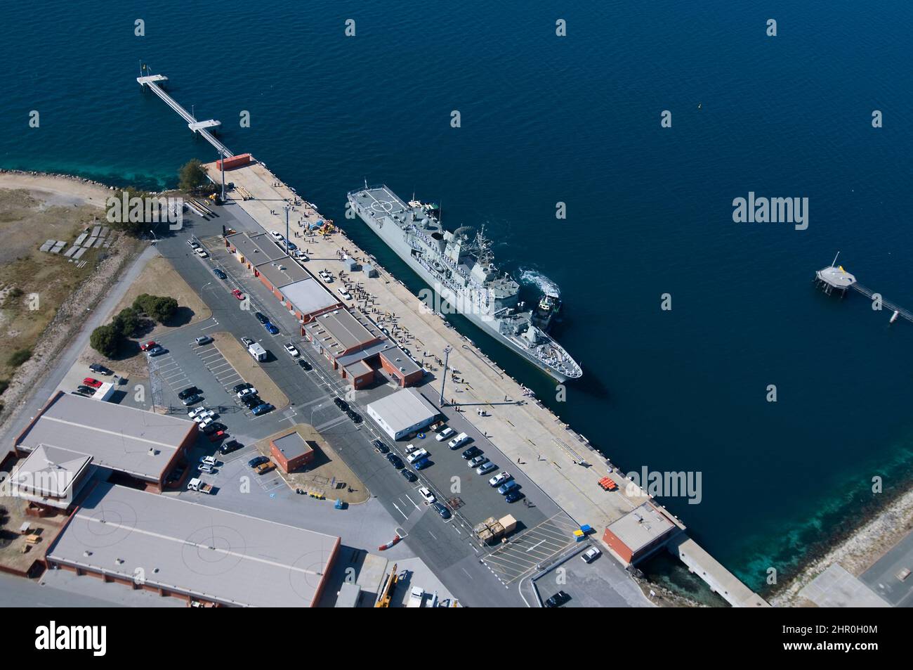 A Royal Australian Navy frigate berthing at Western Australia's Garden Island naval base, following an overseas deployment. Stock Photo