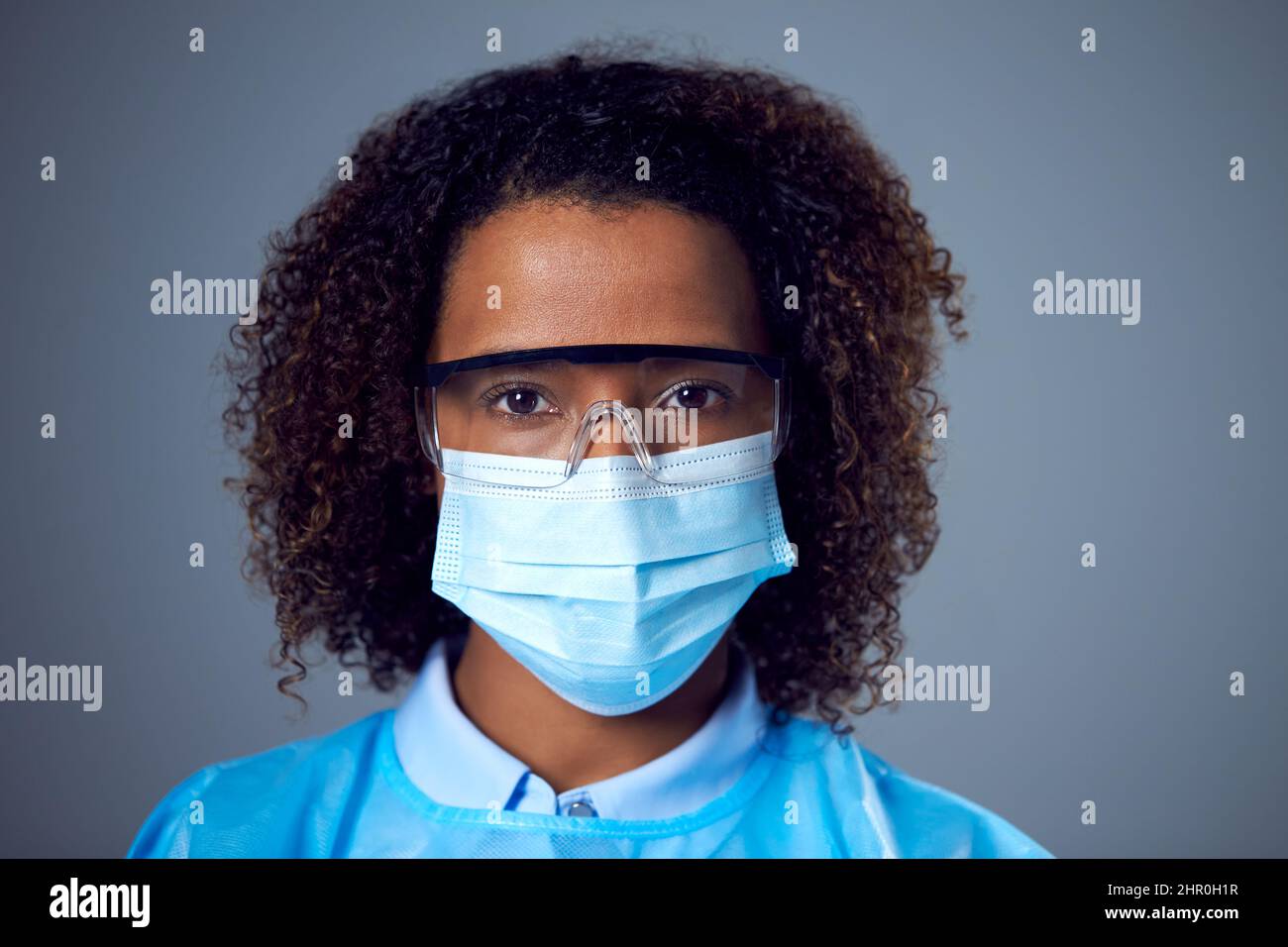Studio Portrait Of Female Lab Worker in PPE With Face Mask And Safety ...