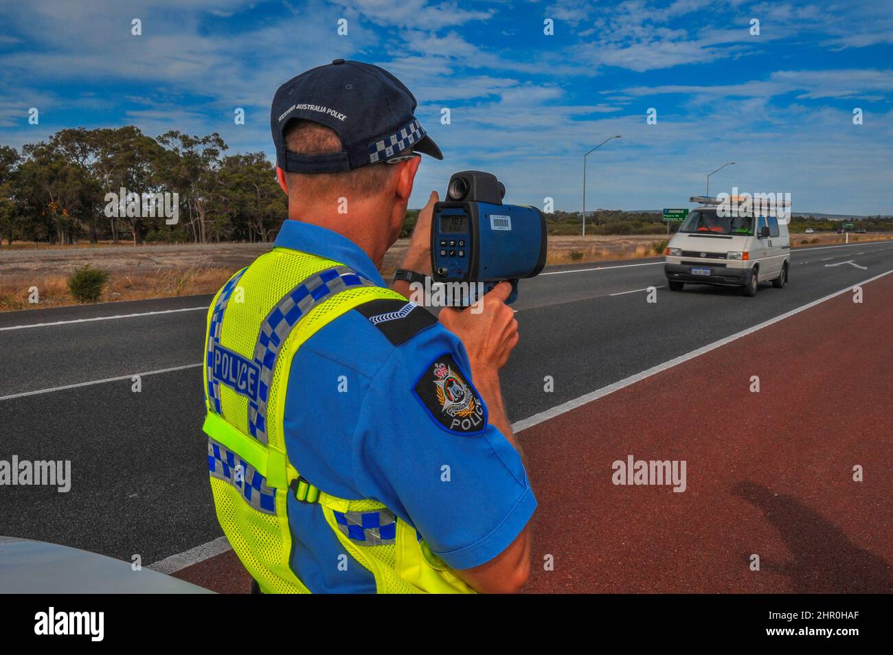 Western Australia Police (WAPOL) traffic officer in action on a country road, checking for speeding cars. Stock Photo