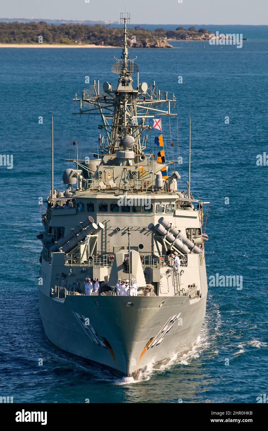 A Royal Australian Navy frigate berthing at Western Australia's Garden Island naval base, following an overseas deployment. Stock Photo