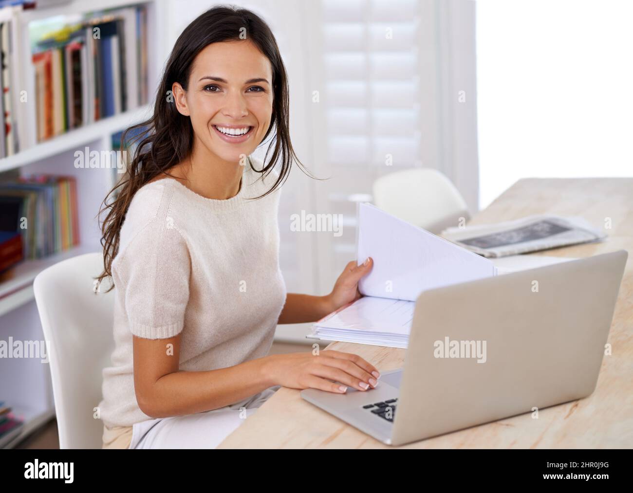 Enjoying the internet and all its freedom. Portrait of an attractive young woman using her laptop at home. Stock Photo