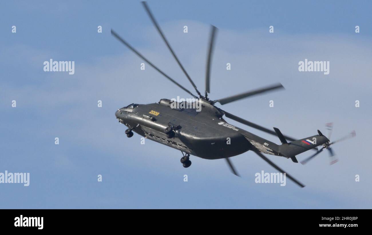Moscow Russia AUGUST, 26, 2015 Mil Mi-26 Halo Soviet Russian military heavy transport helicopter in flight in the blue sky. Mil Mi-26 Halo is the largest and most powerful helicopter in the World. Stock Photo