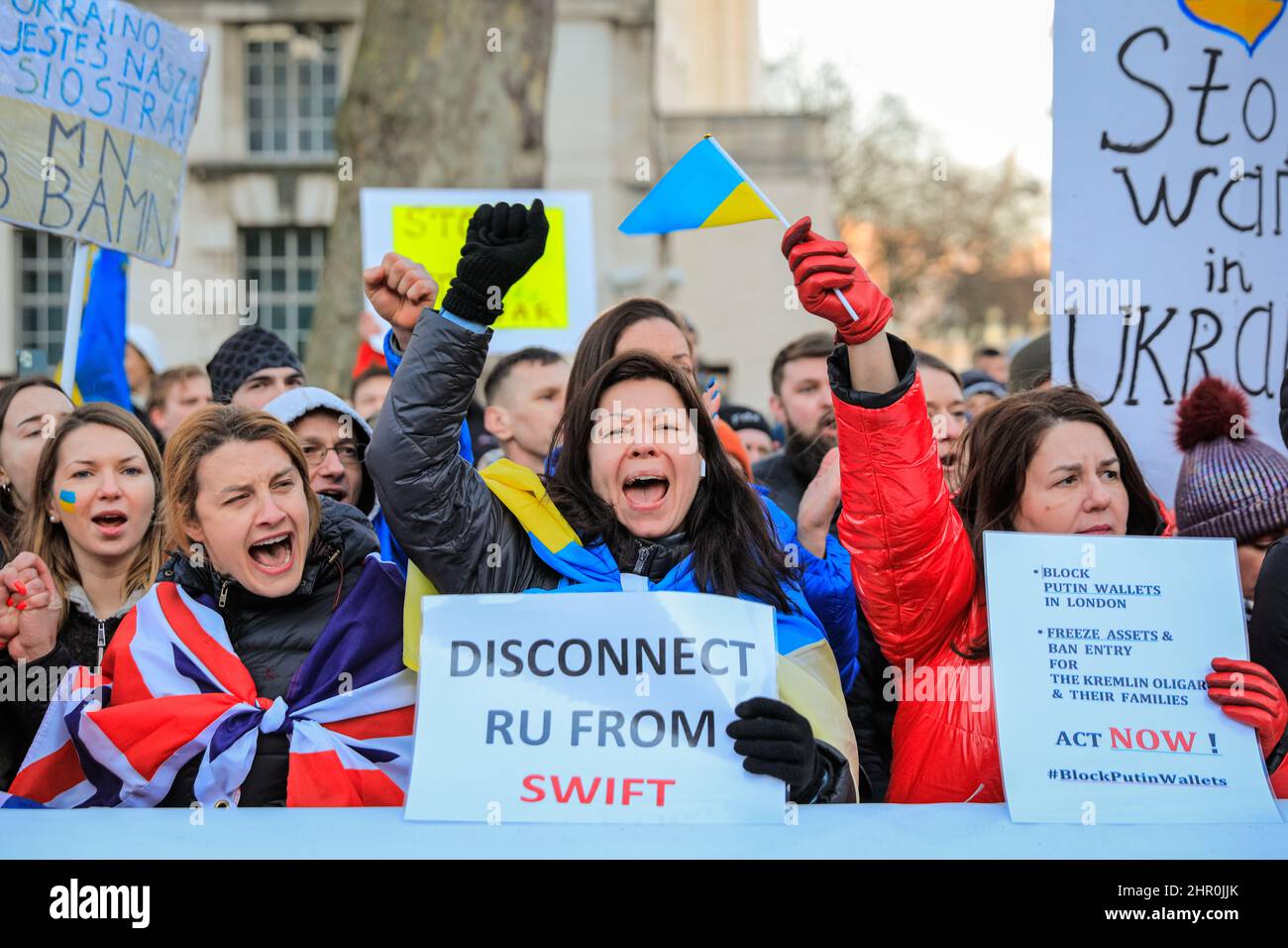 London, UK. 24th Feb, 2022. The crowd cheers as a speaker confirms further sanctions against Russia have been announced by the British government. Several hundred people rally and protest opposite Downing Street in London against Russia's aggression in Ukraine this evening. Credit: Imageplotter/Alamy Live News Stock Photo