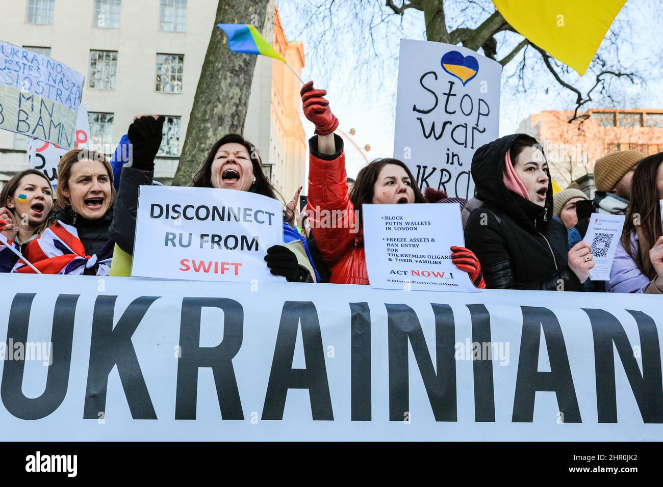 London, UK. 24th Feb, 2022. The crowd cheers as a speaker confirms further sanctions against Russia have been announced by the British government. Several hundred people rally and protest opposite Downing Street in London against Russia's aggression in Ukraine this evening. Credit: Imageplotter/Alamy Live News Stock Photo
