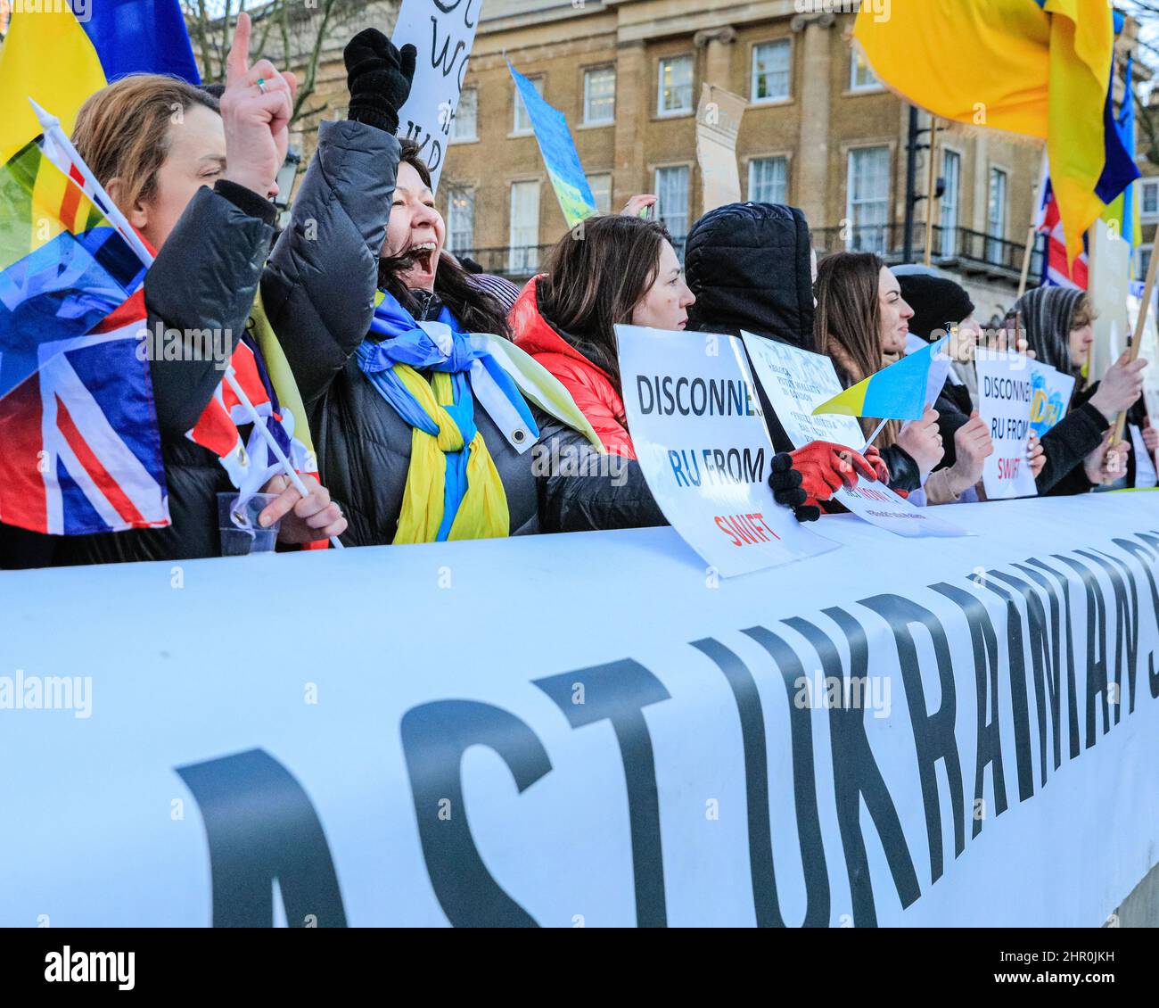 London, UK. 24th Feb, 2022. The crowd cheers as a speaker confirms further sanctions against Russia have been announced by the British government. Several hundred people rally and protest opposite Downing Street in London against Russia's aggression in Ukraine this evening. Credit: Imageplotter/Alamy Live News Stock Photo