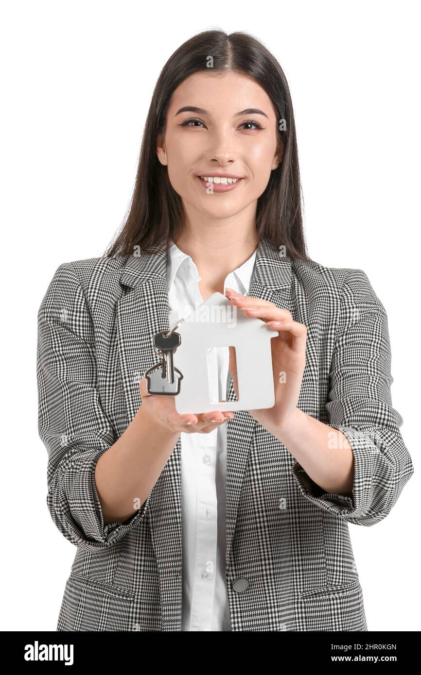 Real estate agent with figure of house and key on white background