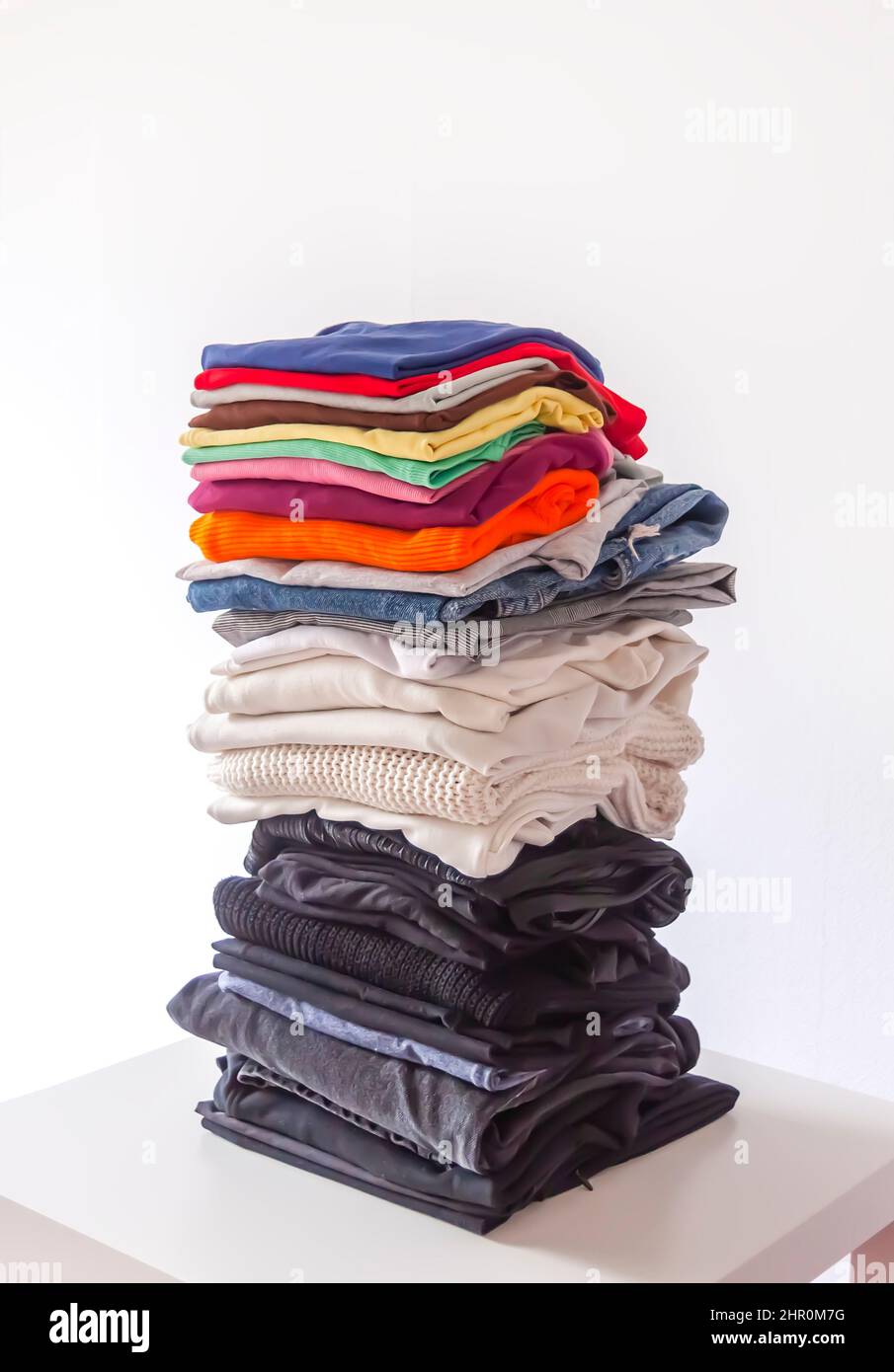 Folded colorful clothes in a stack. Home organizing. Domestic storage ...