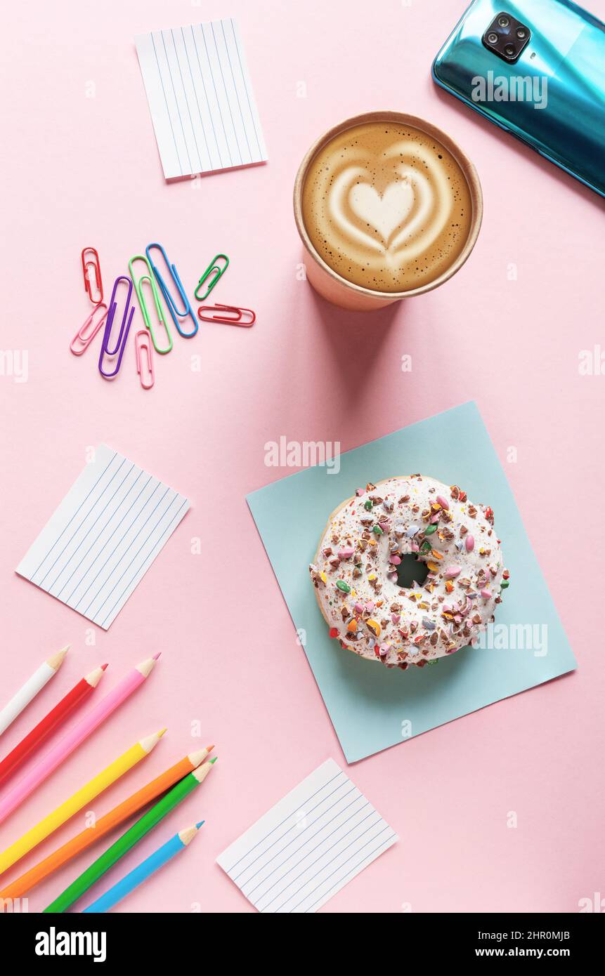 Coffee break with donut on the pink table background Stock Photo