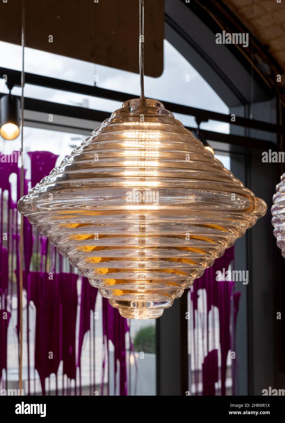 Glass pendant light by the name Press, hanging in the Tom Dixon flagship store and showroom at Coal Drops Yard, Kings Cross, London UK. Stock Photo