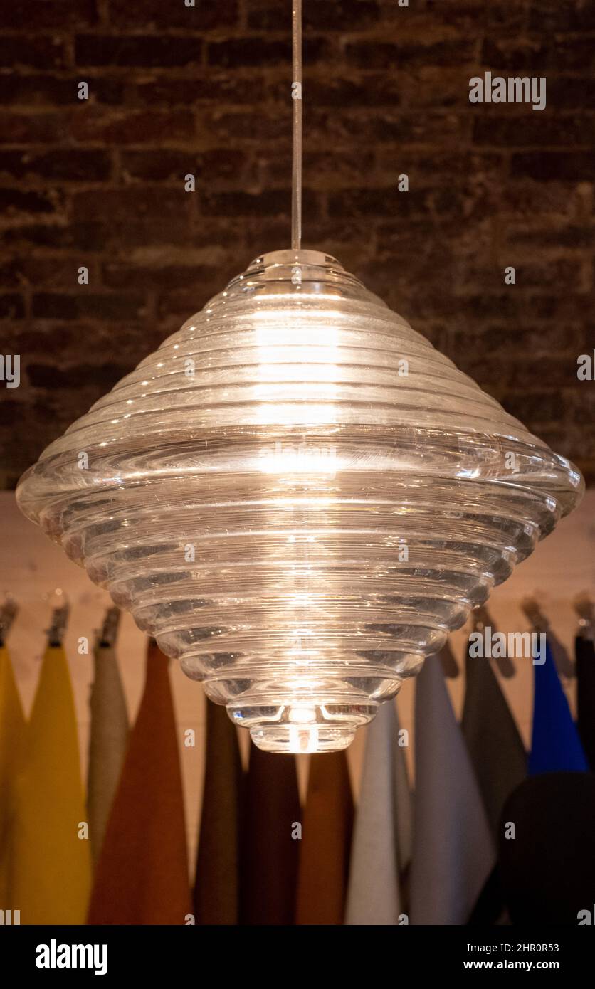 Glass pendant light by the name Press, hanging in the Tom Dixon flagship store and showroom at Coal Drops Yard, Kings Cross, London UK. Stock Photo
