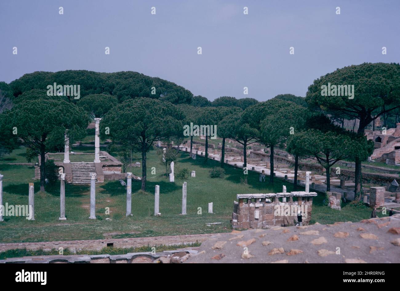 Ostia Antica - large archaeological site in progress, location of the harbour city of ancient Rome.  Piazzale delle Corporazioni (Square of the Corporations) from Temple of Ceres.  Archival scan from a slide. April 1970. Stock Photo