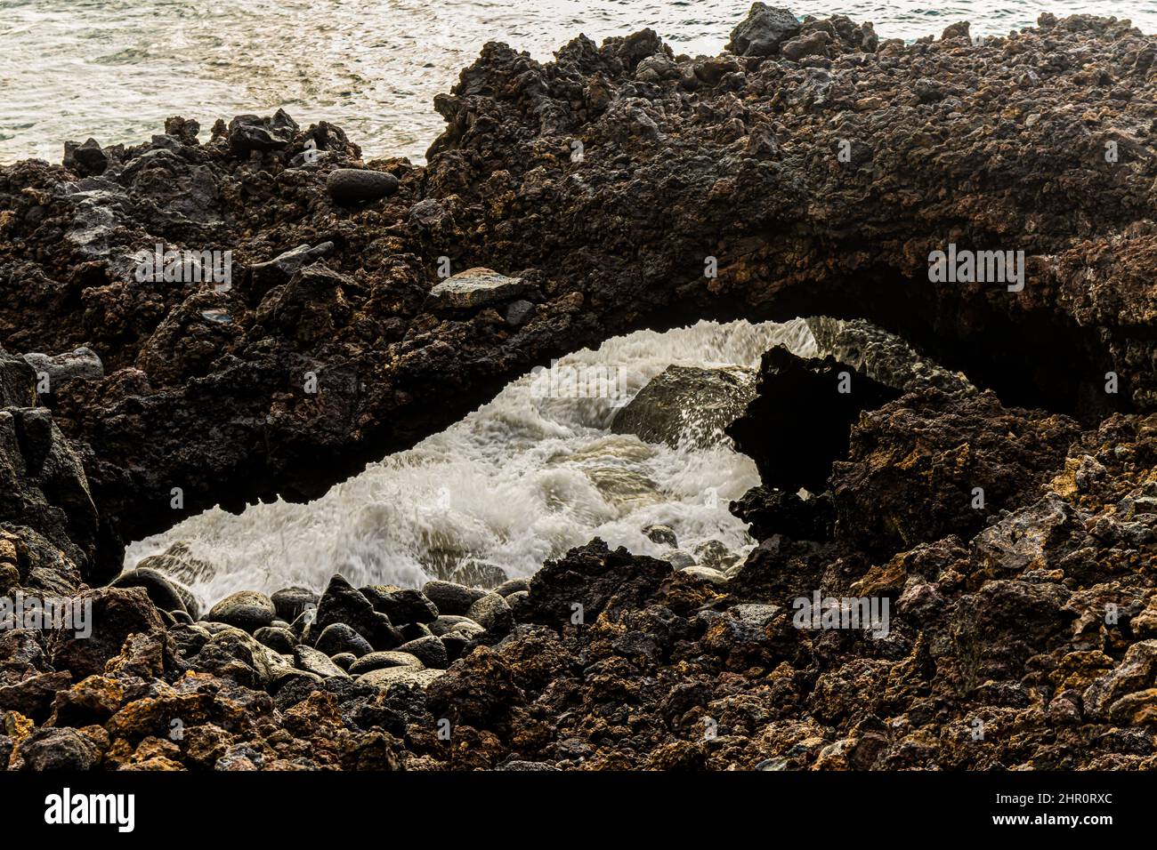 Sea Arch on  Lava Shoreline on Honomolino Beach, Hawaii Island, Hawaii, USA Stock Photo