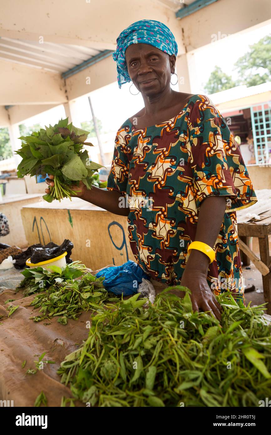 An African Woman Sells Produce At Her Market Stall In Tanaff Senegal An African Woman Sells Produce At Her Market Stall In Tanaff Senegal