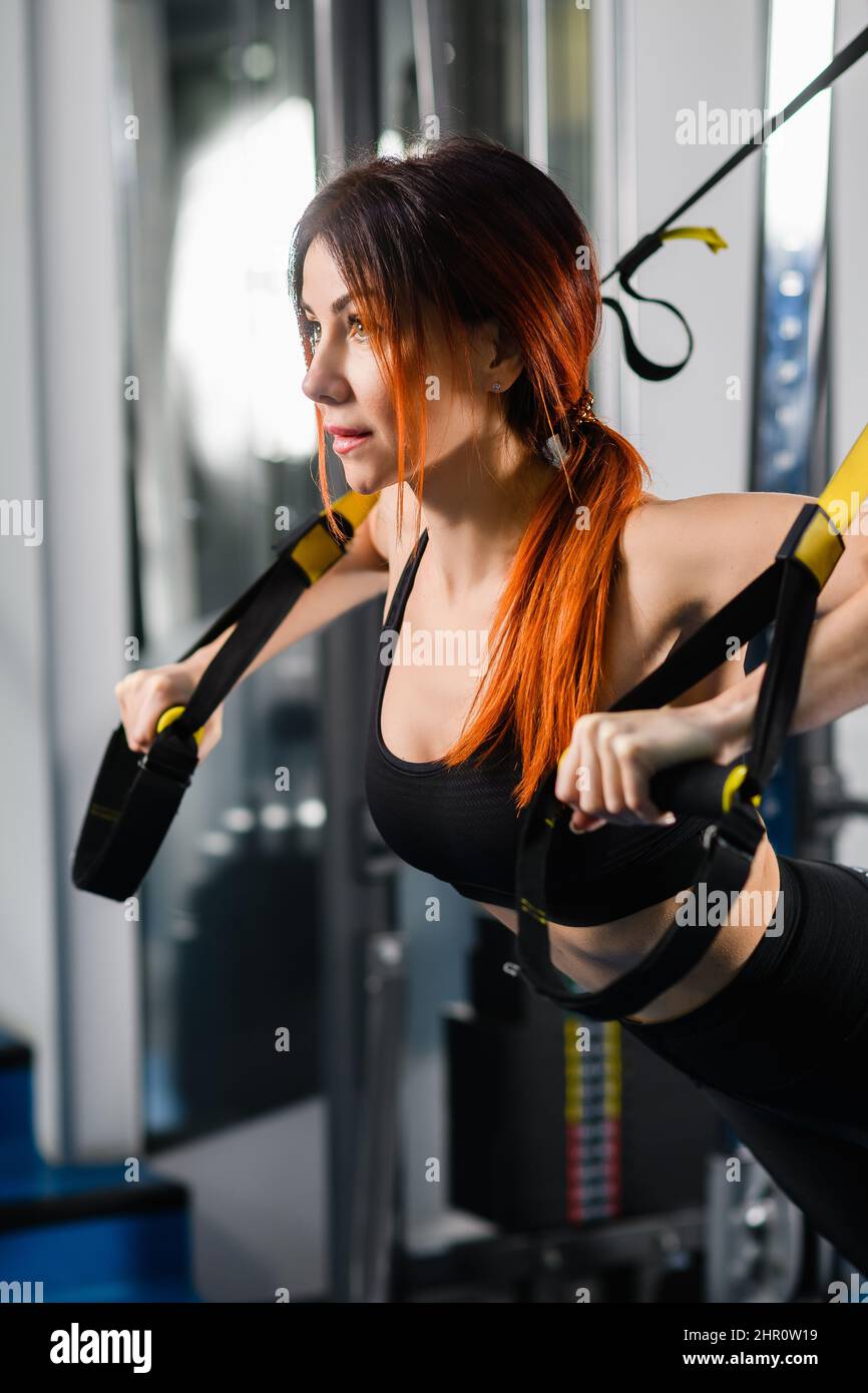 Side view. Young athletic woman with perfect body in sportswear doing ...
