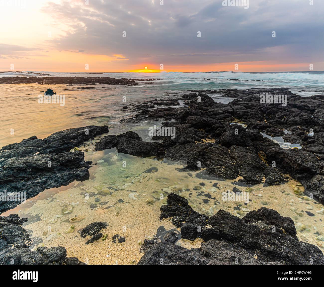 Sunset Over Tide Pools at Miloloi'i Beach Park, Captain Cook, Hawaii Island, Hawaii, USA Stock Photo
