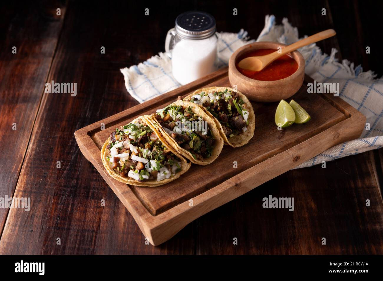 Tacos de Suadero. Fried meat in a corn tortilla. Street food from CDMX, Mexico, traditionally accompanied with cilantro, onion and spicy red sauce Stock Photo