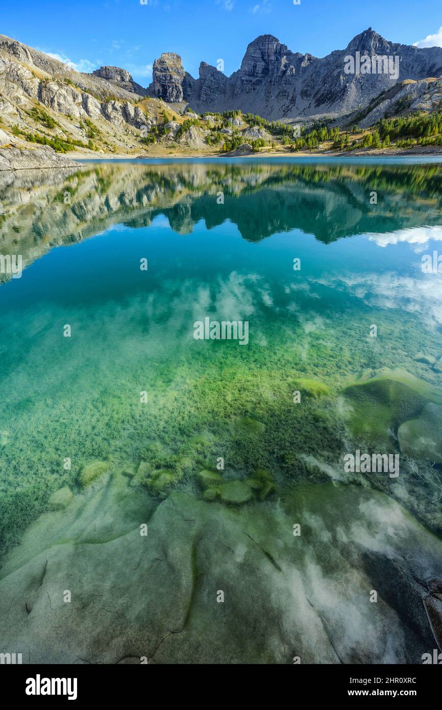 The lake of Allos and its sandstone towers of Annot, in the Haut Verdon, Alpes de Haute-Provence. A very pure lake, populated by Arctic char and trout Stock Photo