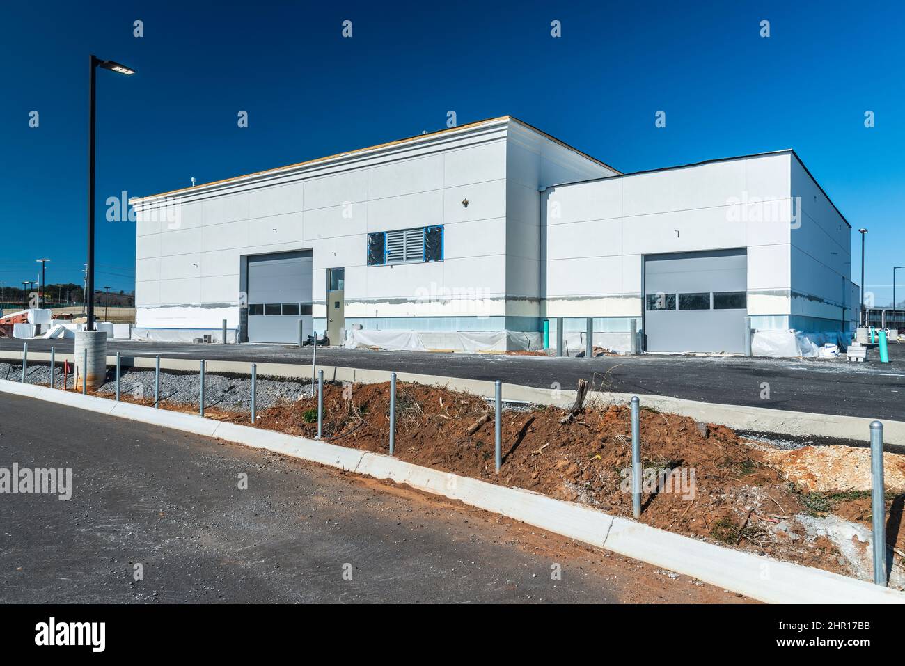 Horizontal shot of the garage entrance to a new industrial building under construction with copy space. Stock Photo