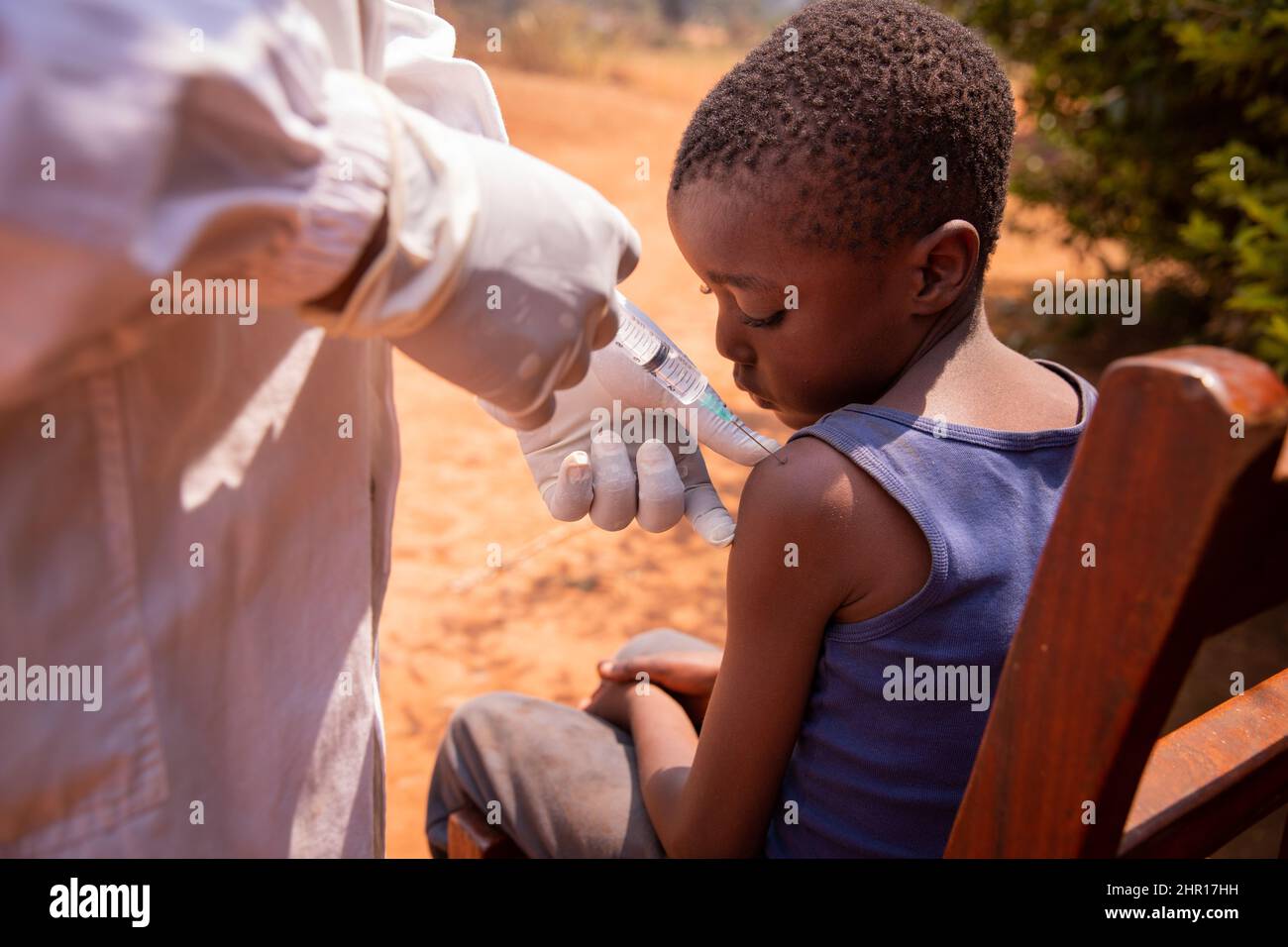 Close-up of a doctor injecting the vaccine to a child in africa. Stock Photo