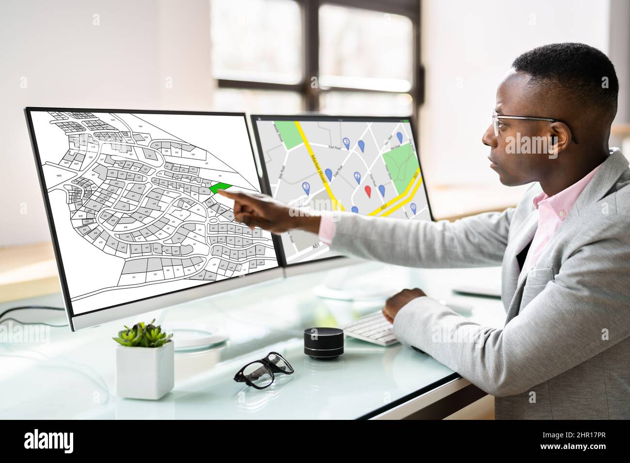 African American Using Cadastral Map On Tablet Computer Stock Photo