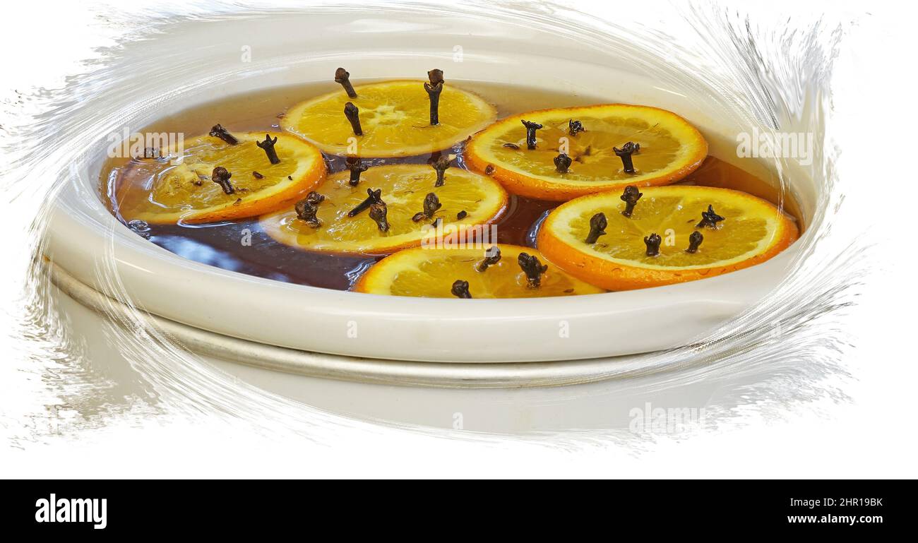 Holiday Drink - Hot Spices Apple Cider - A crock pot full of hot spiced apple cider with orange slices and cloves floating on top. Stock Photo