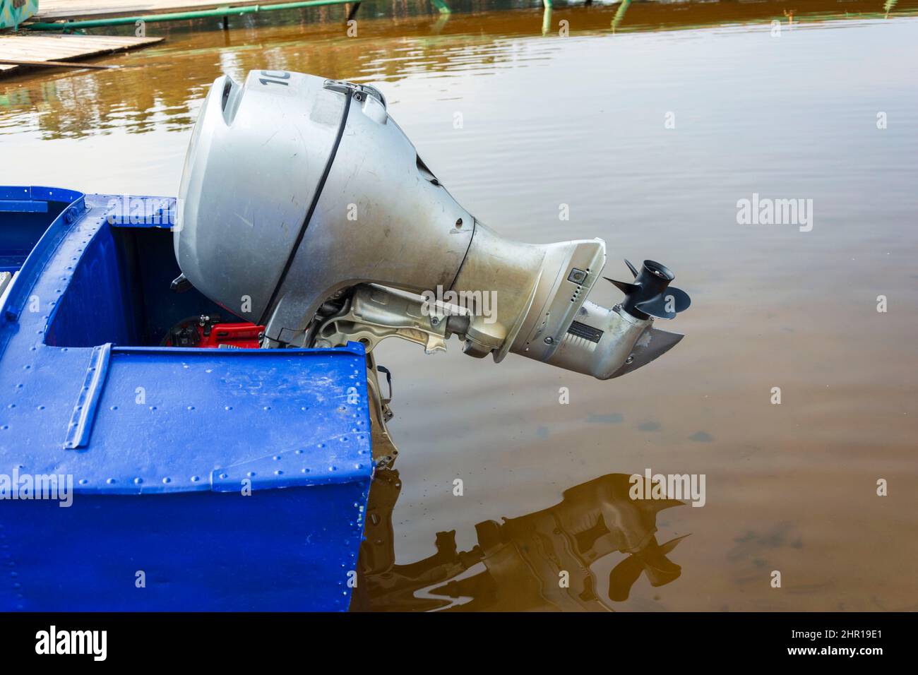 Outboard motor on a blue aluminum fishing boat, outboard motor on a