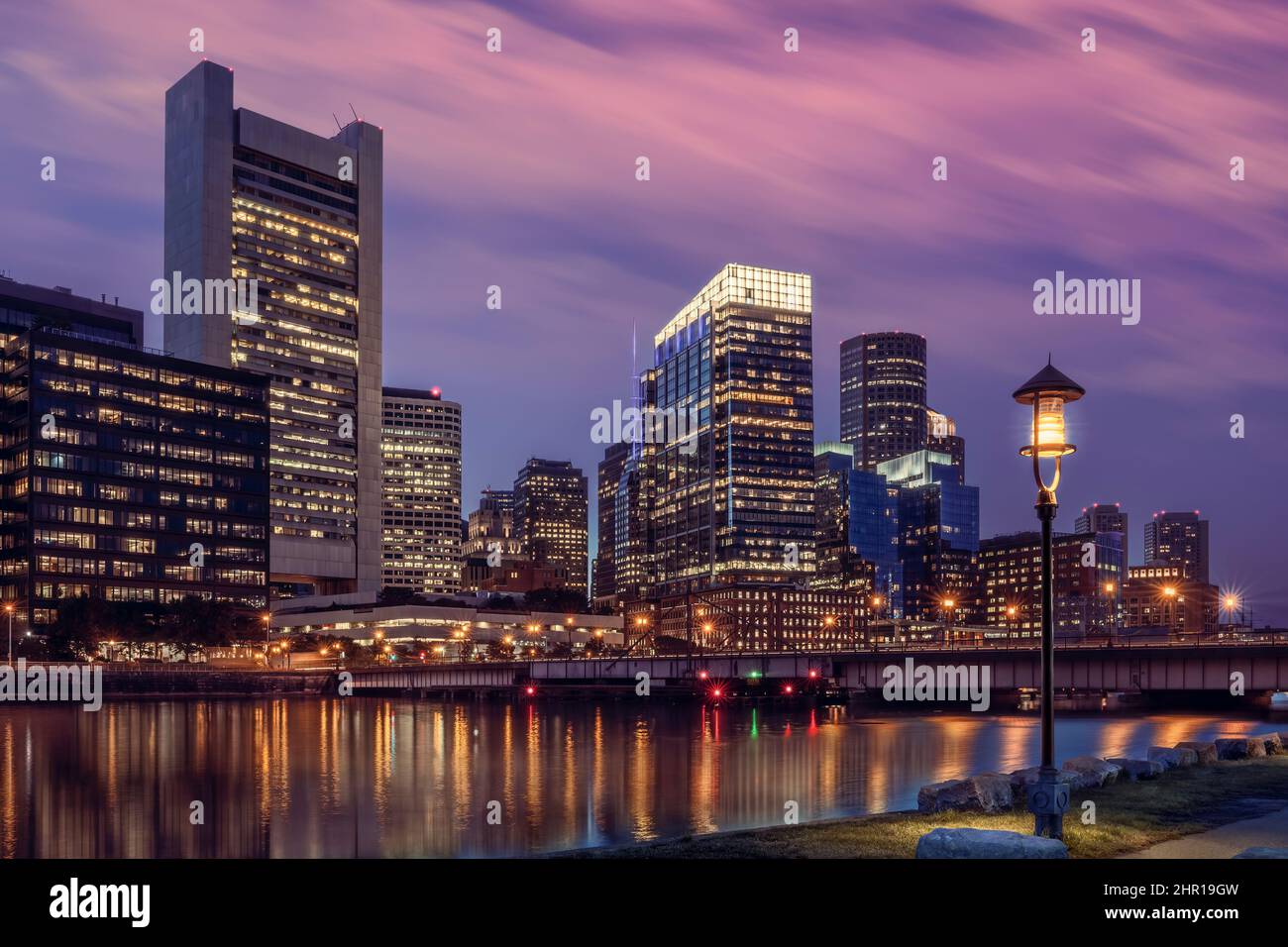 The early evening lights of the financial district of Boston reflect across the waters of the Fort Point Channel. Boston, Massachusetts - USA Stock Photo