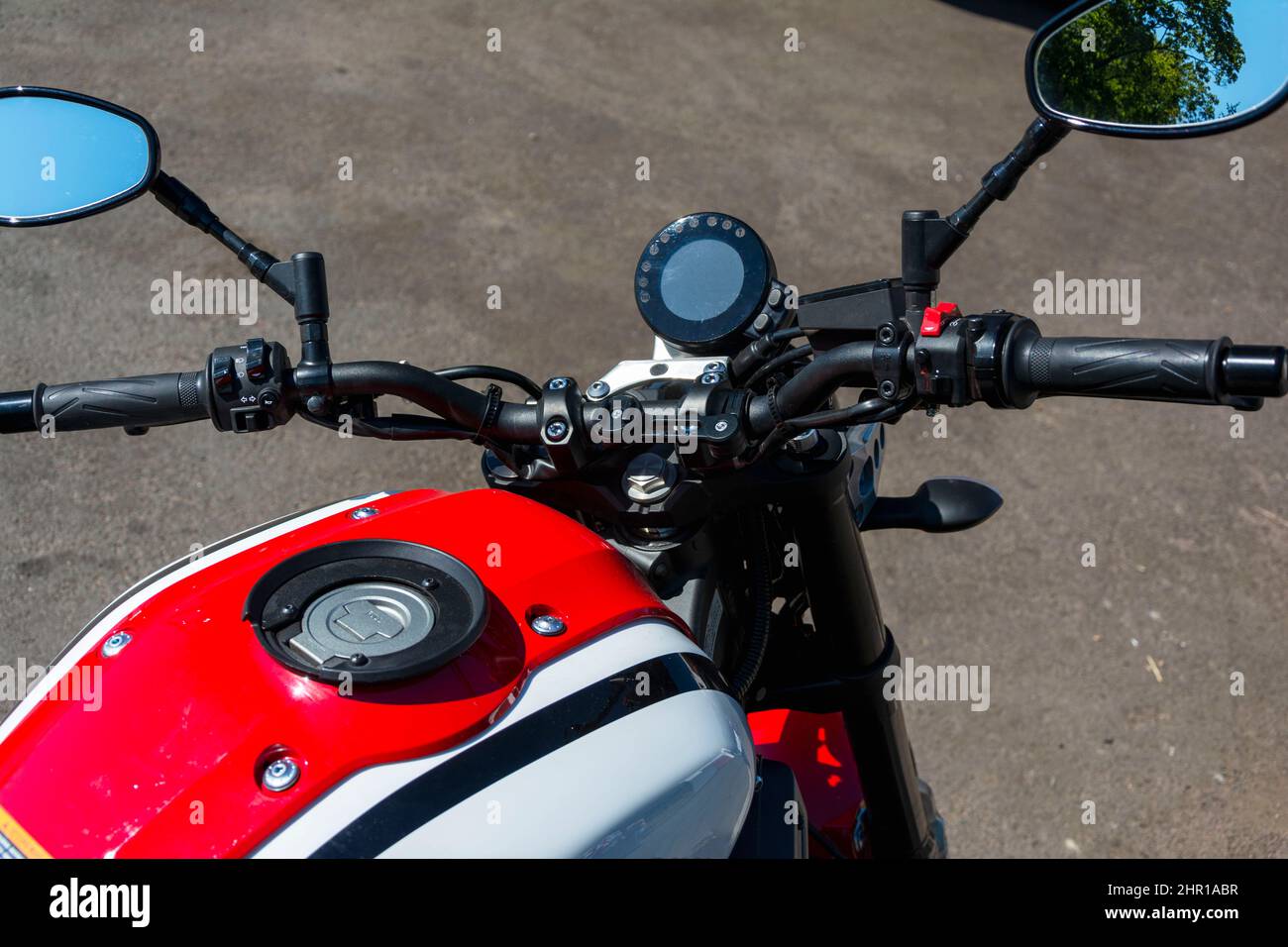 Beautiful top view of a motorcycle, red motorcycle gas tank, motorcycle steering wheel, speedometer, Shining chrome, gas handle, Stylish motorcycle lo Stock Photo