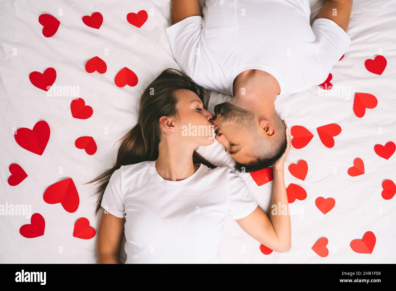 Romantic couple kissing in bed hi-res stock photography and images - Alamy